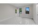 Bedroom features two windows, light-colored walls and flooring, and white trim at 2305 Turners Aly, Raleigh, NC 27607