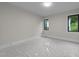 Bright bedroom with two windows and neutral walls. The floor is covered with protective plastic at 2305 Turners Aly, Raleigh, NC 27607