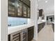 Sophisticated butler's pantry with dark wood cabinets, wine fridge, and stylish backsplash, ideal for serving and storage at 2305 Turners Aly, Raleigh, NC 27607