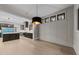 Open dining area with view of the kitchen and natural light through multiple windows at 2305 Turners Aly, Raleigh, NC 27607