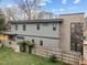 Modern two-story home featuring sleek gray siding and brick accents, complemented by a well-maintained lawn and wooden fence at 2305 Turners Aly, Raleigh, NC 27607