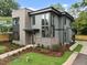 Modern home featuring a gray exterior with a brick accent, professionally landscaped lawn, and a welcoming front entrance at 2305 Turners Aly, Raleigh, NC 27607