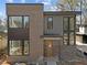 Modern two-story home with brick and gray wood facade featuring large windows and a contemporary design at 2305 Turners Aly, Raleigh, NC 27607