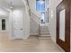 Bright foyer with a staircase, large windows, wood flooring, and a stylish front door creating a welcoming entrance at 2305 Turners Aly, Raleigh, NC 27607