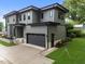 Contemporary home showcasing a spacious driveway leading to a two-car garage with clean lines and modern design at 2305 Turners Aly, Raleigh, NC 27607