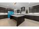 Spacious kitchen with dark wood cabinets, white countertops, large island, and modern lighting at 2305 Turners Aly, Raleigh, NC 27607