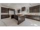 Spacious kitchen showcasing dark wood cabinets and a central island, all in the finishing stages at 2305 Turners Aly, Raleigh, NC 27607
