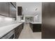 Open kitchen with stainless steel appliances, a center island, and modern lighting, perfect for cooking and entertaining at 2305 Turners Aly, Raleigh, NC 27607
