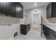 Laundry room with black cabinets, granite countertops, and stainless steel sink at 2305 Turners Aly, Raleigh, NC 27607
