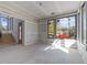 Bright living room with large windows, offering abundant natural light and neighborhood views at 2305 Turners Aly, Raleigh, NC 27607