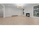 Bright living room features a modern fireplace, beautiful hardwood floors, and a stylish light fixture at 2305 Turners Aly, Raleigh, NC 27607