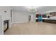 Open living area with fireplace, view of the kitchen, and contemporary lighting fixtures at 2305 Turners Aly, Raleigh, NC 27607