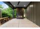 Covered outdoor living space featuring a modern fireplace and tranquil backyard view at 2305 Turners Aly, Raleigh, NC 27607