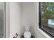 Modern powder room with a toilet, window, and sleek fixtures at 2305 Turners Aly, Raleigh, NC 27607