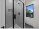 Modern shower with gray subway tile, glass door and window at 2305 Turners Aly, Raleigh, NC 27607