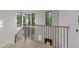 Elegant staircase features wood and black iron banister and lots of natural light from multiple windows at 2305 Turners Aly, Raleigh, NC 27607