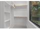 Organized walk-in closet with shelving, hanging rods, and a window for natural light at 2305 Turners Aly, Raleigh, NC 27607