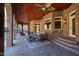 Covered outdoor patio featuring brick columns, stone flooring, and an elegant dining set for alfresco meals at 2421 Acanthus Dr, Wake Forest, NC 27587