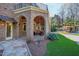 Covered patio with brick arches, stone flooring, and an outdoor seating area, perfect for entertaining at 2421 Acanthus Dr, Wake Forest, NC 27587
