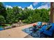 Relax on the terrace with an elevated view of the lush backyard featuring an outdoor pool and mature trees at 2421 Acanthus Dr, Wake Forest, NC 27587