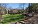 Expansive backyard with stone steps, a lush lawn, and manicured landscaping at 2421 Acanthus Dr, Wake Forest, NC 27587