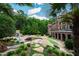 Gorgeous backyard with a lagoon-style pool, grotto, slide, fireplace, and ample seating areas at 2421 Acanthus Dr, Wake Forest, NC 27587