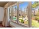 Window view of the backyard featuring mature trees and a pool at 2421 Acanthus Dr, Wake Forest, NC 27587