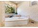Bathroom featuring an elegant white jacuzzi tub and a large window at 2421 Acanthus Dr, Wake Forest, NC 27587