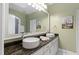 Elegant bathroom featuring double sinks with granite countertops and a large mirror at 2421 Acanthus Dr, Wake Forest, NC 27587