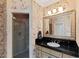 Elegant bathroom with a granite countertop, decorative wallpaper, and a glass door shower at 2421 Acanthus Dr, Wake Forest, NC 27587