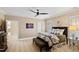 Cozy bedroom with ceiling fan, ensuite bathroom, and natural light from window with shutters at 2421 Acanthus Dr, Wake Forest, NC 27587