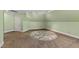 Large carpeted bonus room with an inlaid tile circle, neutral paint, and bright lighting at 2421 Acanthus Dr, Wake Forest, NC 27587