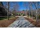 Long driveway leading to a beautiful home, surrounded by lush landscaping and mature trees at 2421 Acanthus Dr, Wake Forest, NC 27587
