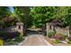 View of the property entrance featuring brick pillars, an iron gate, and a landscaped driveway at 2421 Acanthus Dr, Wake Forest, NC 27587