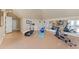 Home exercise room featuring an elliptical machine, treadmill, mirrors, and cork flooring at 2421 Acanthus Dr, Wake Forest, NC 27587
