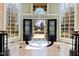 Welcoming foyer with black and white tile, arched windows, and ornate doors at 2421 Acanthus Dr, Wake Forest, NC 27587