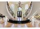 Dramatic foyer with a sweeping staircase, chandelier, marble flooring, and soaring ceilings at 2421 Acanthus Dr, Wake Forest, NC 27587