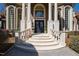 Elegant front entrance with stone steps, stately columns, and arched windows providing curb appeal at 2421 Acanthus Dr, Wake Forest, NC 27587