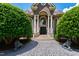 Elegant home entrance showcasing a grand doorway, manicured landscaping, and a brick walkway at 2421 Acanthus Dr, Wake Forest, NC 27587
