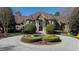 Stunning brick home featuring a circular driveway, well-manicured landscaping, and classic architectural details at 2421 Acanthus Dr, Wake Forest, NC 27587