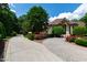Brick home on a large manicured lot, has mature landscaping and a winding driveway at 2421 Acanthus Dr, Wake Forest, NC 27587