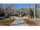 Majestic brick home with lush landscaping and a circular driveway, nestled among mature trees at 2421 Acanthus Dr, Wake Forest, NC 27587