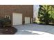 Expansive brick home featuring a large garage with multiple doors and a well-maintained driveway and landscaping at 2421 Acanthus Dr, Wake Forest, NC 27587
