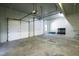 Spacious garage with ample room for parking and storage, featuring an overhead door system and concrete flooring at 2421 Acanthus Dr, Wake Forest, NC 27587