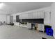 Well-organized garage featuring ample cabinet storage and a workbench area at 2421 Acanthus Dr, Wake Forest, NC 27587