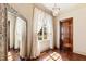 Bright hallway featuring hardwood floors, large windows, and elegant decor at 2421 Acanthus Dr, Wake Forest, NC 27587