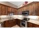 Well-appointed kitchen featuring granite counters, wood cabinetry, and stainless steel appliances at 2421 Acanthus Dr, Wake Forest, NC 27587