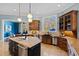 Open-concept kitchen with pendant lighting, stainless steel appliances, and eat-in bar at 2421 Acanthus Dr, Wake Forest, NC 27587