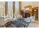 Bright living room featuring high ceilings, large windows, a fireplace, and plush seating at 2421 Acanthus Dr, Wake Forest, NC 27587