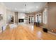 Expansive living room featuring hardwood floors, a fireplace, and staircase to an elevated space, offering a grand ambiance at 2421 Acanthus Dr, Wake Forest, NC 27587